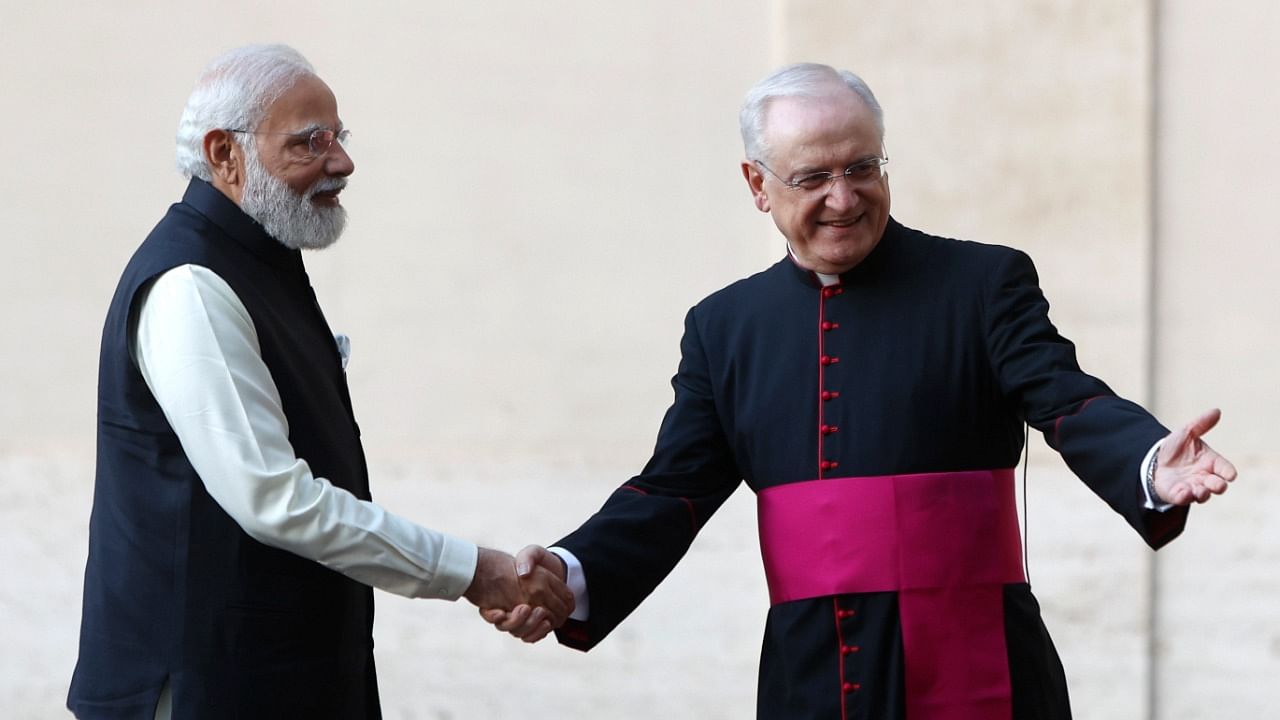 India's Prime Minister Narendra Modi, center, is greeted by the Head of the Papal Household, Mons. Leonardo Sapienza as he arrives for a meeting with Pope Francis at the Vatican, Saturday. Credit: AP/PTI Photo