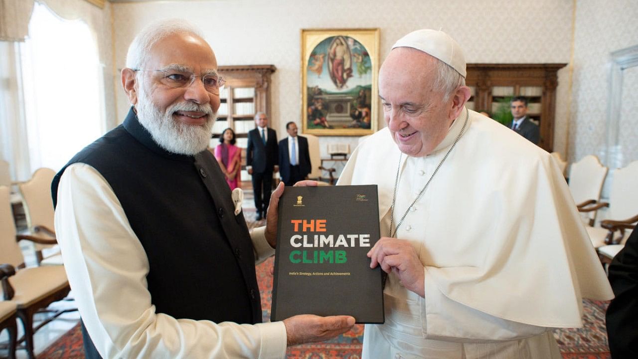 Prime Minister Narendra Modi, left, and Pope Francis exchange gifts on the occasion of their private audience at the Vatican. Credit: AP Photo