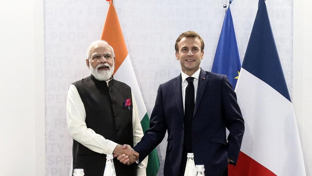Prime Minister Narendra Modi (L) shakes hands with French President Emmanuel Macron (R) during a bilateral meeting at the G20 leaders' summit. Credit: AFP Photo