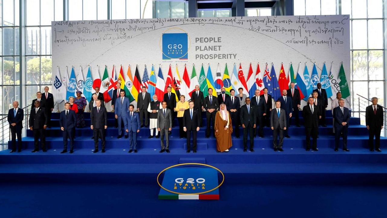 Italian Prime Minister Mario Draghi (C-front) stands with world leaders as they gather for the official family photograph on day one of the G20 Summit at the convention center of La Nuvola. Credit: AFP Photo