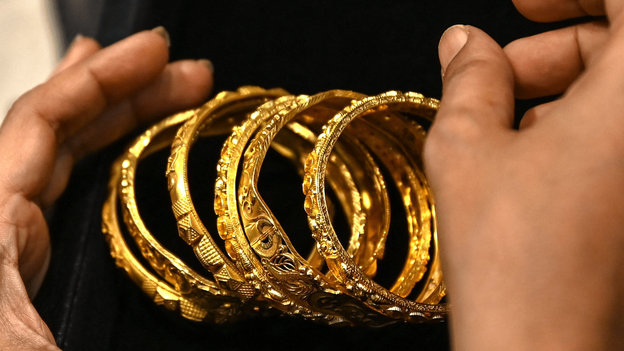 Gold price, which had touched a peak of Rs 56,000 level, on Saturday was ruling over Rs 49,200 per 10 grams level in the country. Credit: AFP Photo