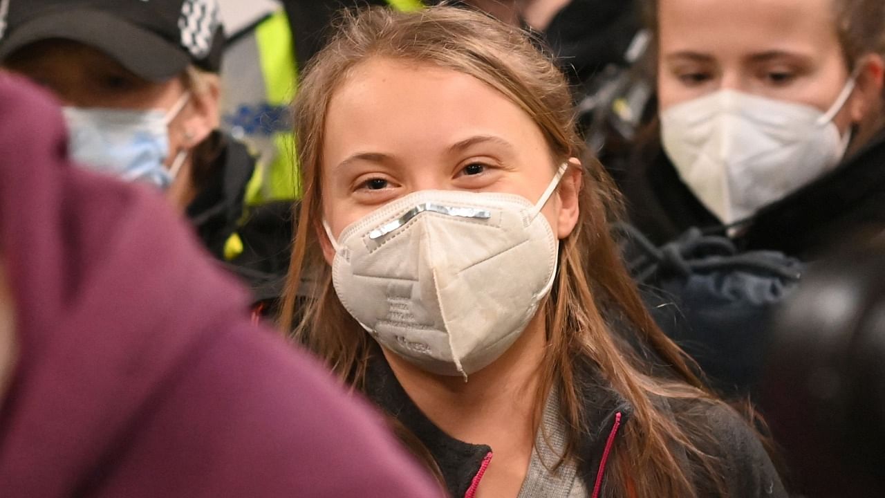 Wearing a face mask as protection against Covid-19, Swedish climate activist Greta Thurnberg arrives at Central station in Glasgow, Scotland on October 30, 2021, ahead of the COP26 UN Climate Change Conference to be held in the city from October 31. Credit: AFP Photo