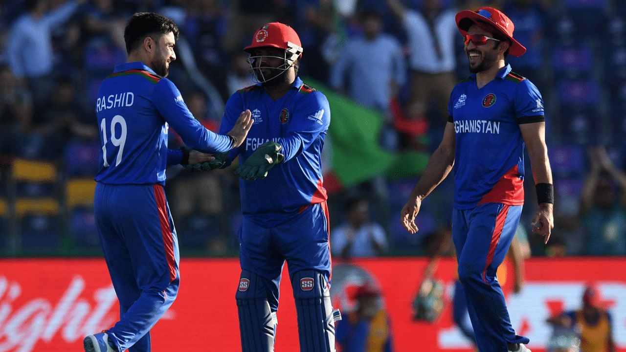 Afghanistan's Rashid Khan (L) celebrates after taking the wicket of Namibia's Zane Green (not pictured) during the ICC men’s Twenty20 World Cup cricket match between Afghanistan and Namibia. Credit: AFP Photo