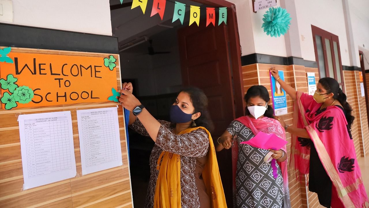 Teachers decorate a classroom at Silver Hills Higher Secondary school, ahead of the reopening of schools in the state, in Kozhikode. Credit: PTI Photo