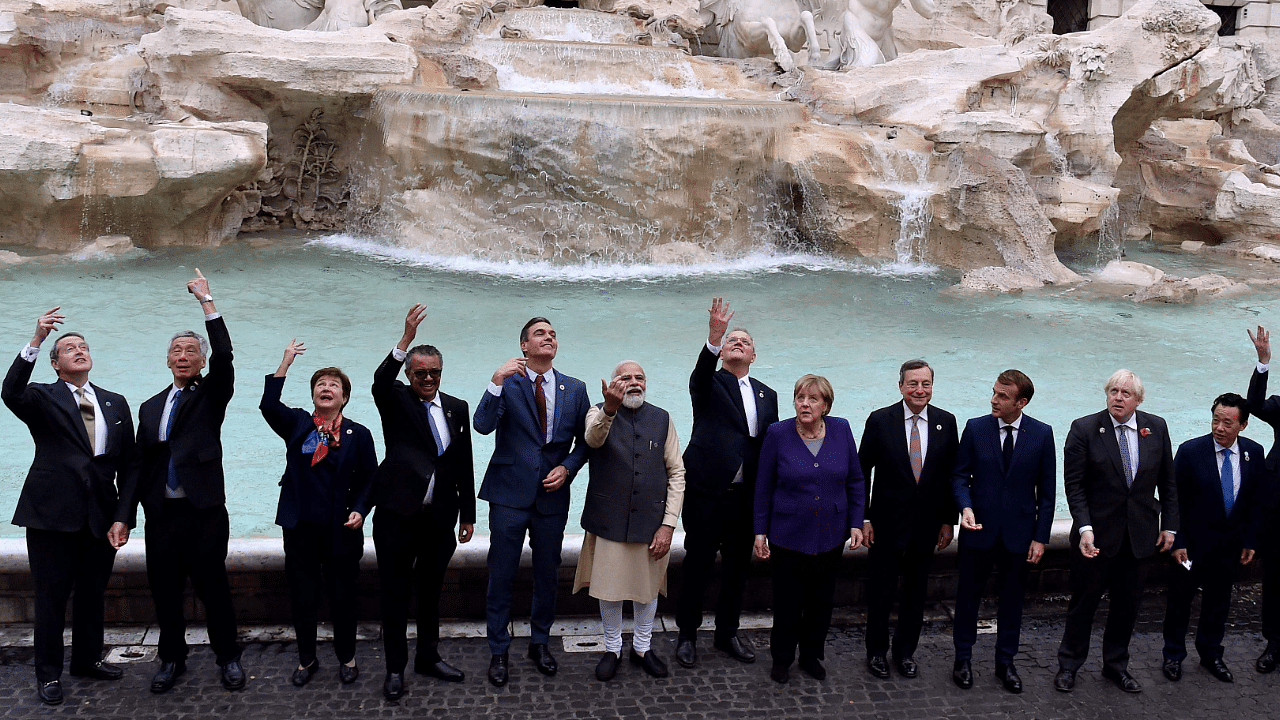 World leaders throw a coin in the water during a visit to the Trevi fountain in central Rome. Credit: AFP Photo