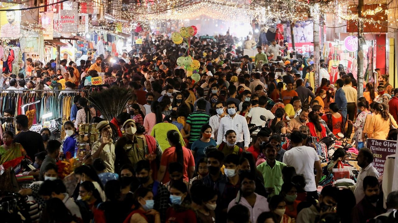 People shop at a crowded market ahead of Diwali, the Hindu festival of lights, during the ongoing coronavirus pandemic, in New Delhi. Credit: Reuters File Photo