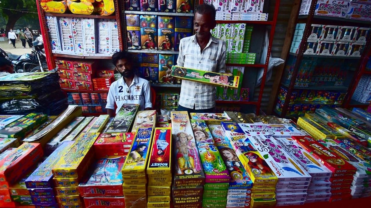 Vendors selling firecrackers wait for customers at a market ahead of Diwali, in Allahabad. Credit: AFP Photo