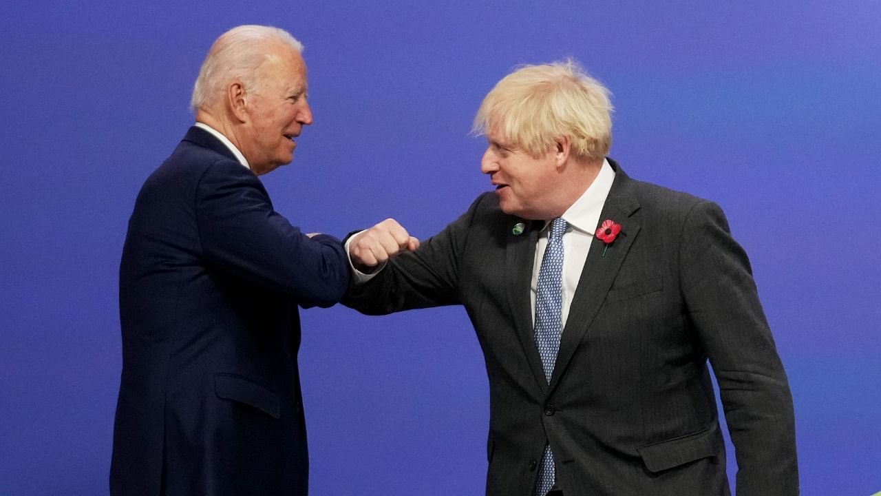 Britain's Prime Minister Boris Johnson (L) greets US President Joe Biden. Credit: AFP Photo