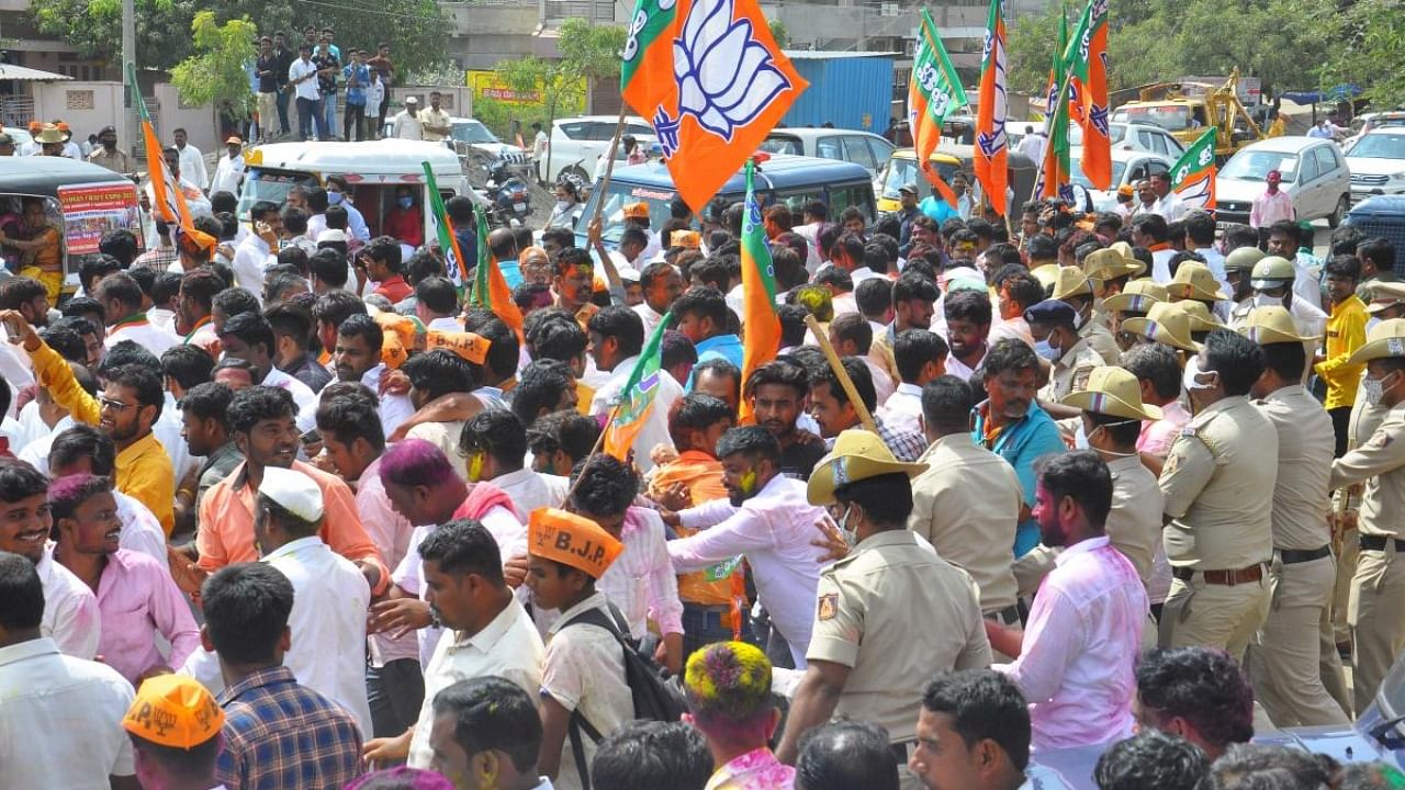 BJP workers celebrate the victory of party candidate Ramesh Bhusanur in the bypolls to Sindgi Assembly constituency, at Vijayapura on Tuesday. Credit: DH Photo