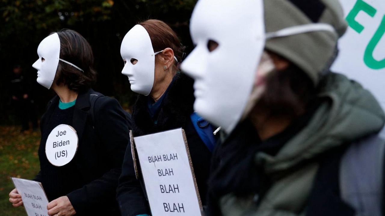Climate activists hold placards reading "Blah Blah Blah" to mock statements by world leaders during a protest at Festival Park in Glasgow on the sidelines of the COP26. Credit: AFP Photo
