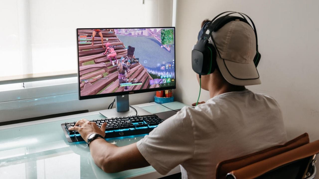 Teenager playing Fortnite video game on PC. Credit: iStock Photo