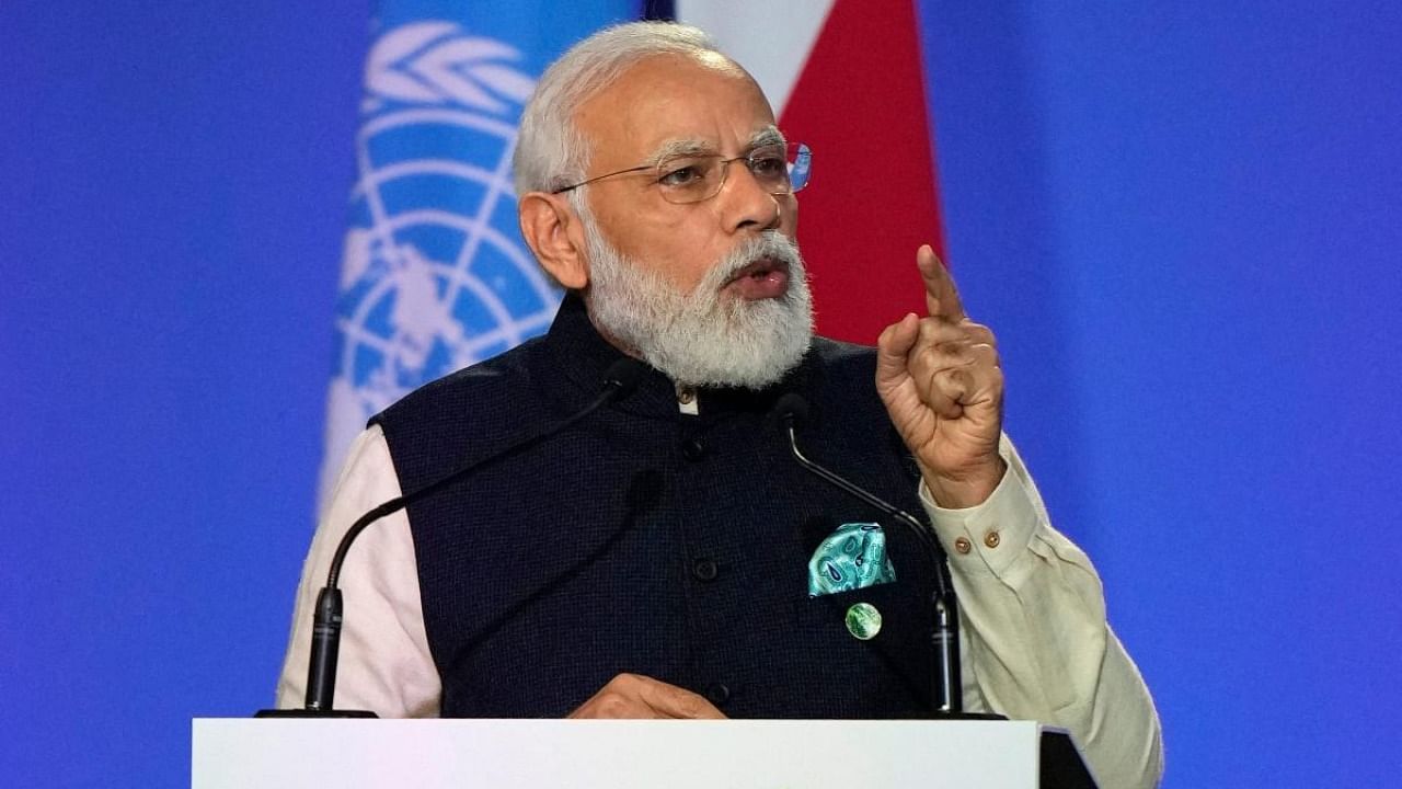 India's Prime Minister Narendra Modi presents his national statement as part of the World Leaders' Summit of the COP26 UN Climate Change Conference in Glasgow. Credit: AFP Photo