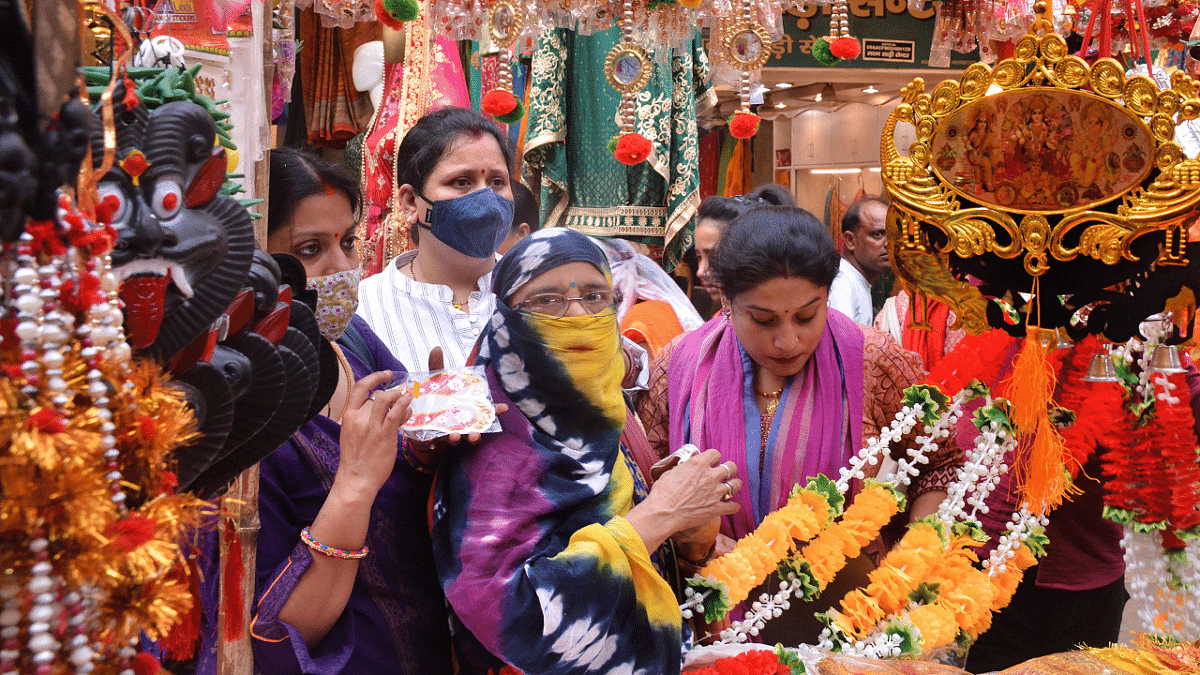 Women shop at the Sisamau market on the eve of Dhanteras. Credit: PTI Photo