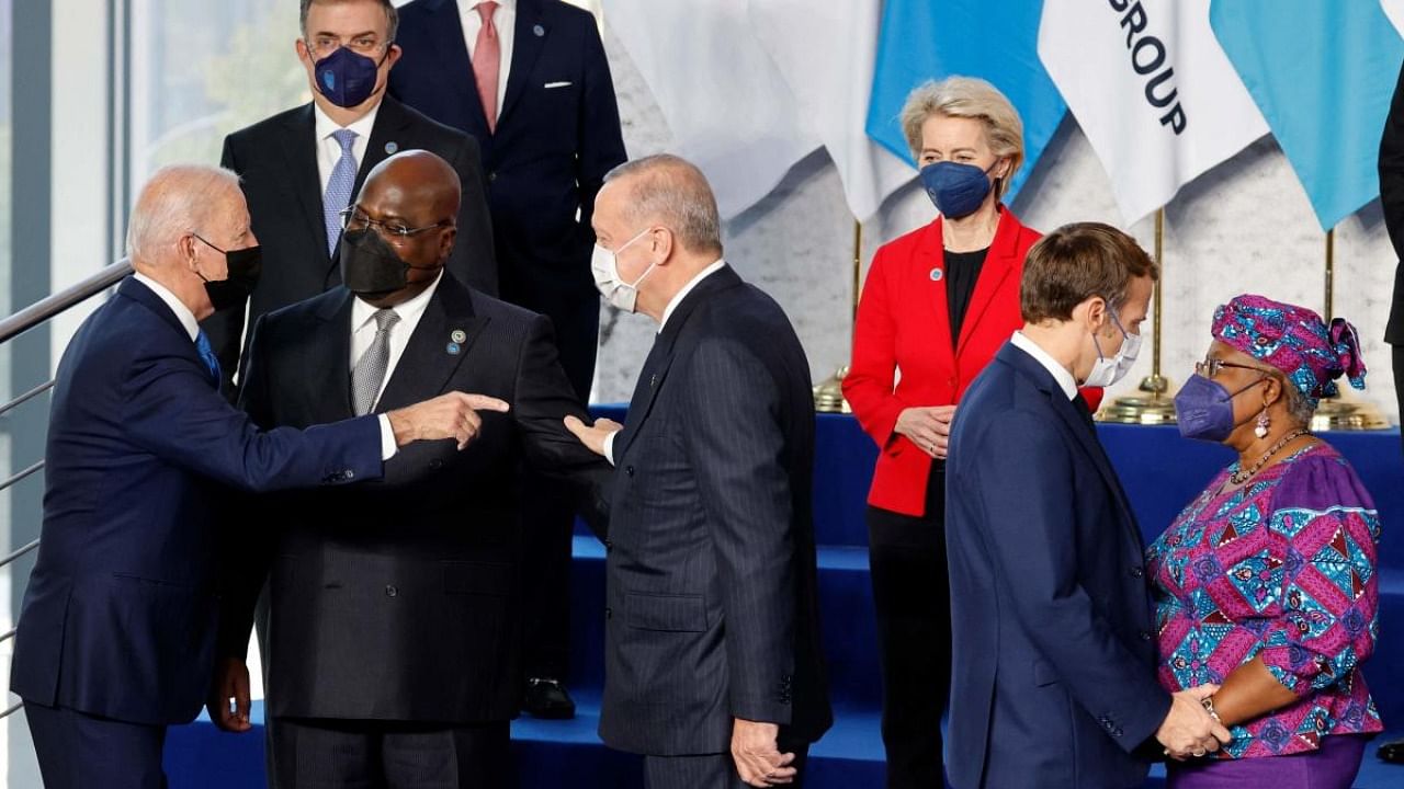 President of the European Commission Ursula von der Leyen (C-back) looks on as US President Joe Biden (L) gestures towards Turkish President Recep Tayyip Erdogan (3rdL) and French President Emmanuel Macron (2nd R) greets Director-General of the World Trade Organization (WTO), Ngozi Okonjo-Iweala (R), at the start of the G20 Summit. Credit: AFP Photo