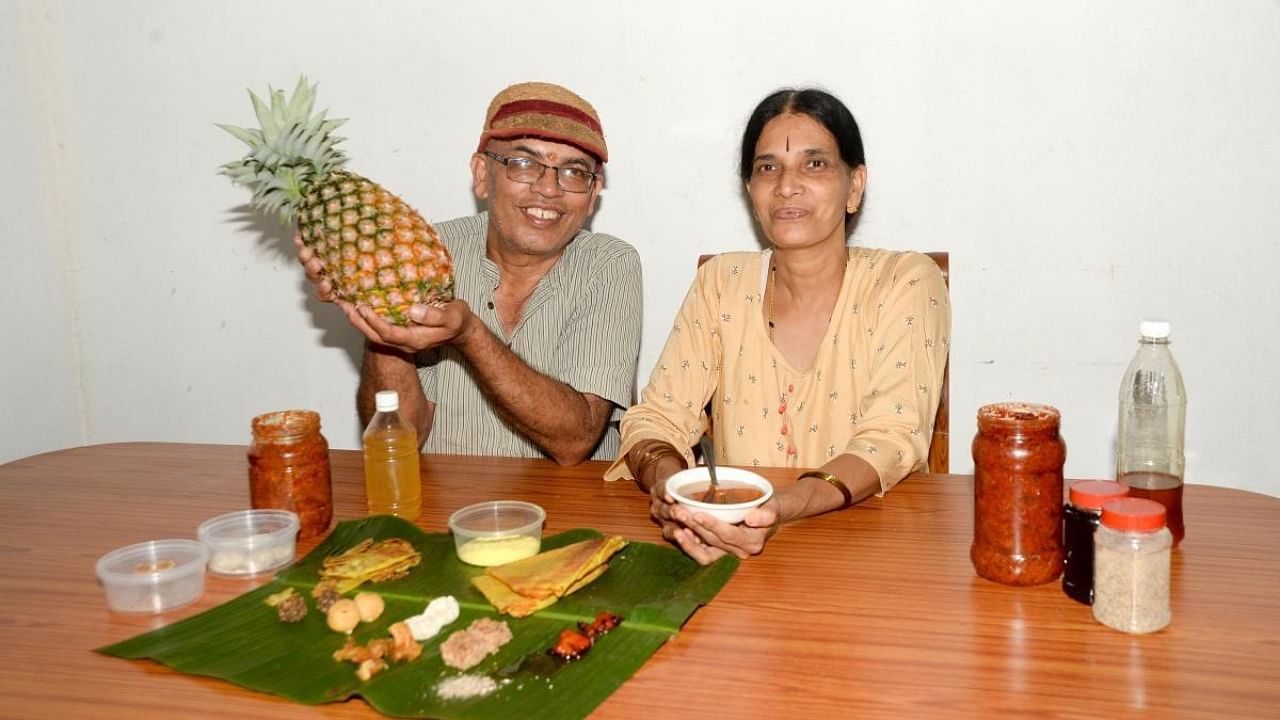 Nagendra Sagar and his wife Vanishri with value-added products made out of pineapple. Credit: DH photo/Sathish Badiger