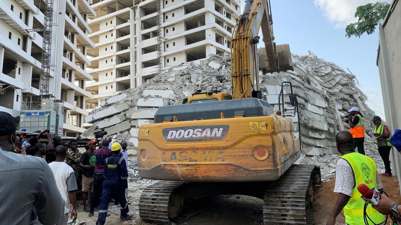 An excavator operates at the site of a collapsed building in Ikoyi, Lagos, Nigeria. Credit: Reuters photo