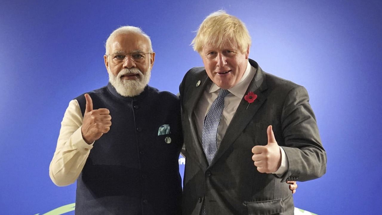 Britain's Prime Minister Boris Johnson greets India's Prime Minister Narendra Modi, left, ahead of their bilateral meeting during the UN Climate Change Conference COP26 in Glasgow. Credit: AP/PTI Photo