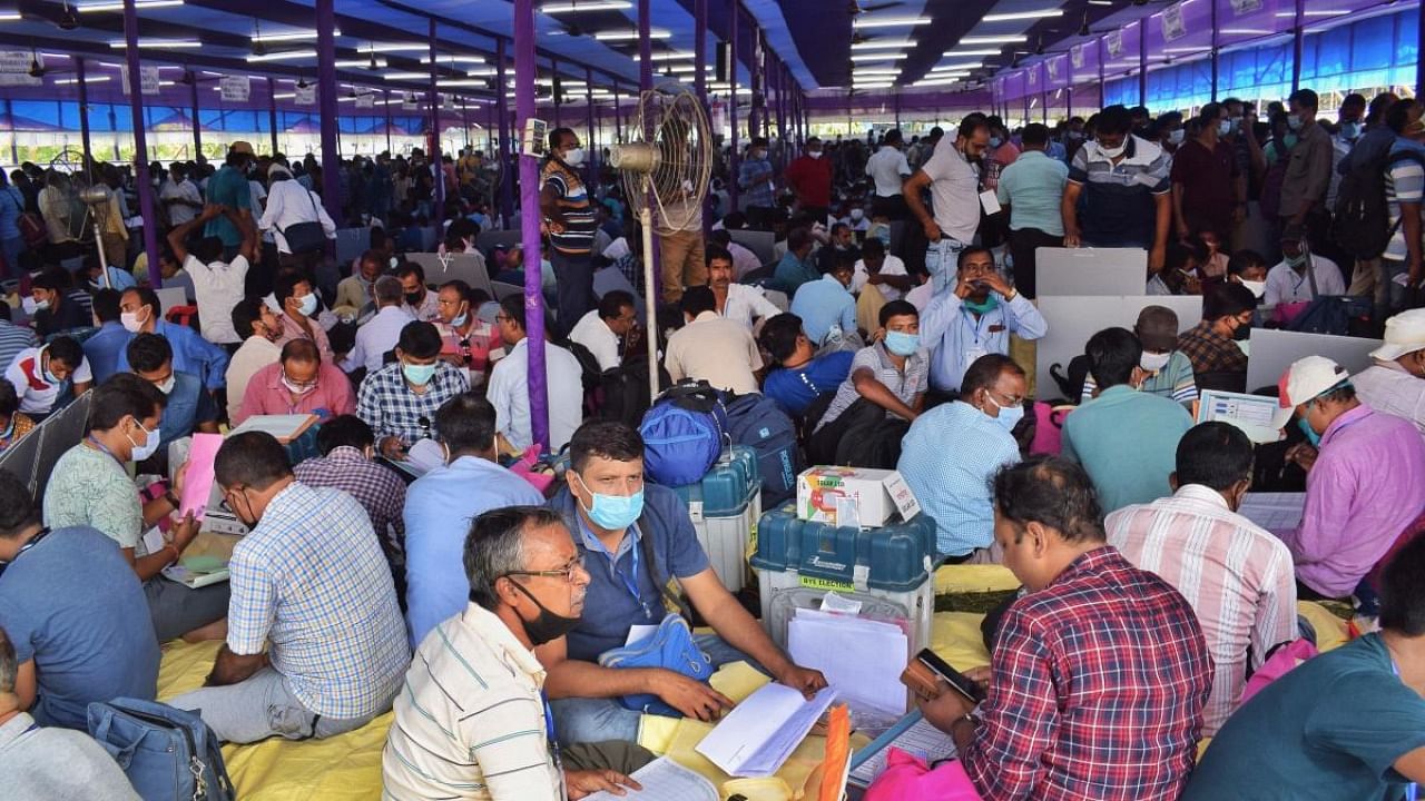 Polling officials collect election material for by-election to Santipur Assembly seat, at a distribution centre in Ranaghat town, Nadia, Friday, Oct 29, 2021. Credit: PTI Photo