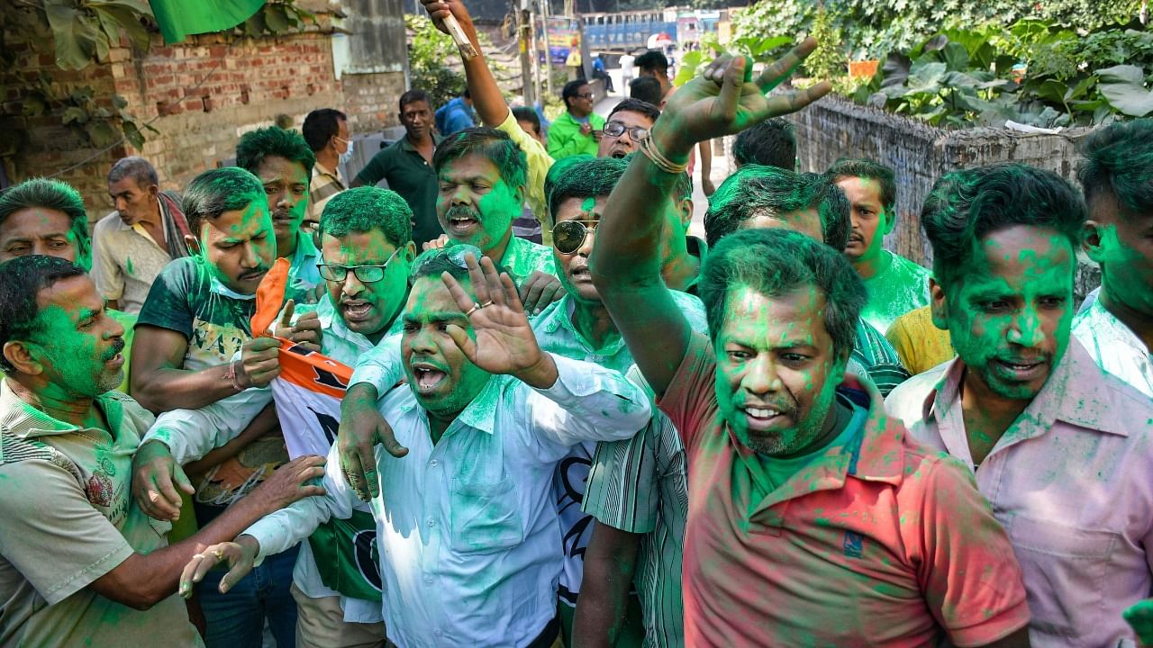 TMC activists celebrate as the party is leading during the counting of votes of all four West Bengal assembly constituencies , in Nadia. Credit: PTI Photo