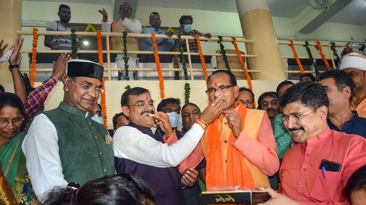 Madhya Pradesh Chief Minister Shivraj Singh along with BJP State President VD Sharma celebrate as party leading in State by-polls, at BJP State headquarters in Bhopal, Tuesday. Credit: PTI File Photo
