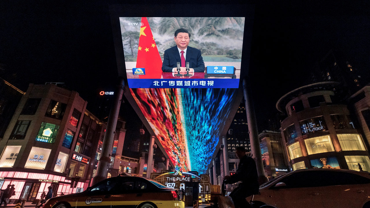 A screen displays a CCTV state media news broadcast showing Chinese President Xi Jinping. Credit: Reuters Photo