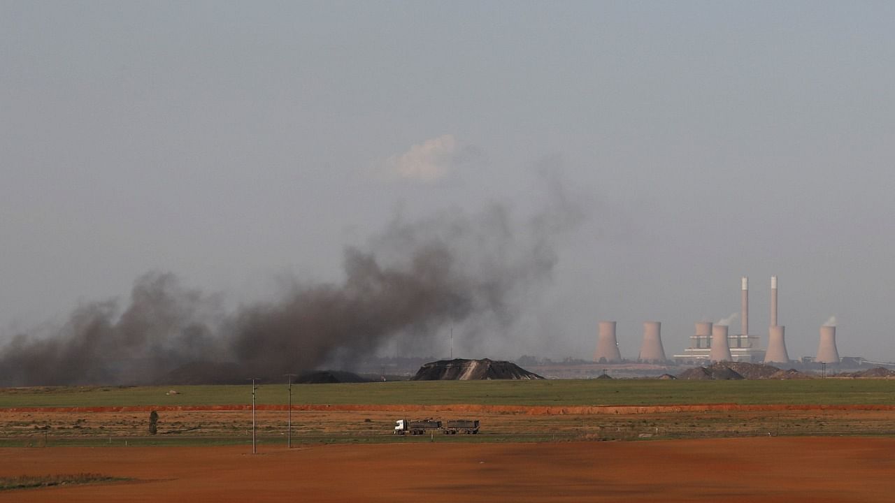 A truck drives past as coal dust rises in front of the Duvha coal-based power station owned by state power utility Eskom, in Emalahleni in Mpumalanga province, South Africa. Credit: Reuters Photo