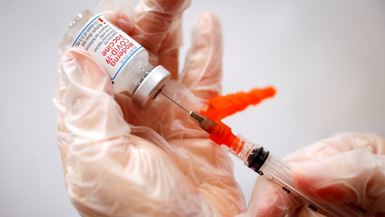 A healthcare worker prepares a syringe with the Moderna Covid-19 Vaccine at a pop-up vaccination site. Credit: Reuters File Photo