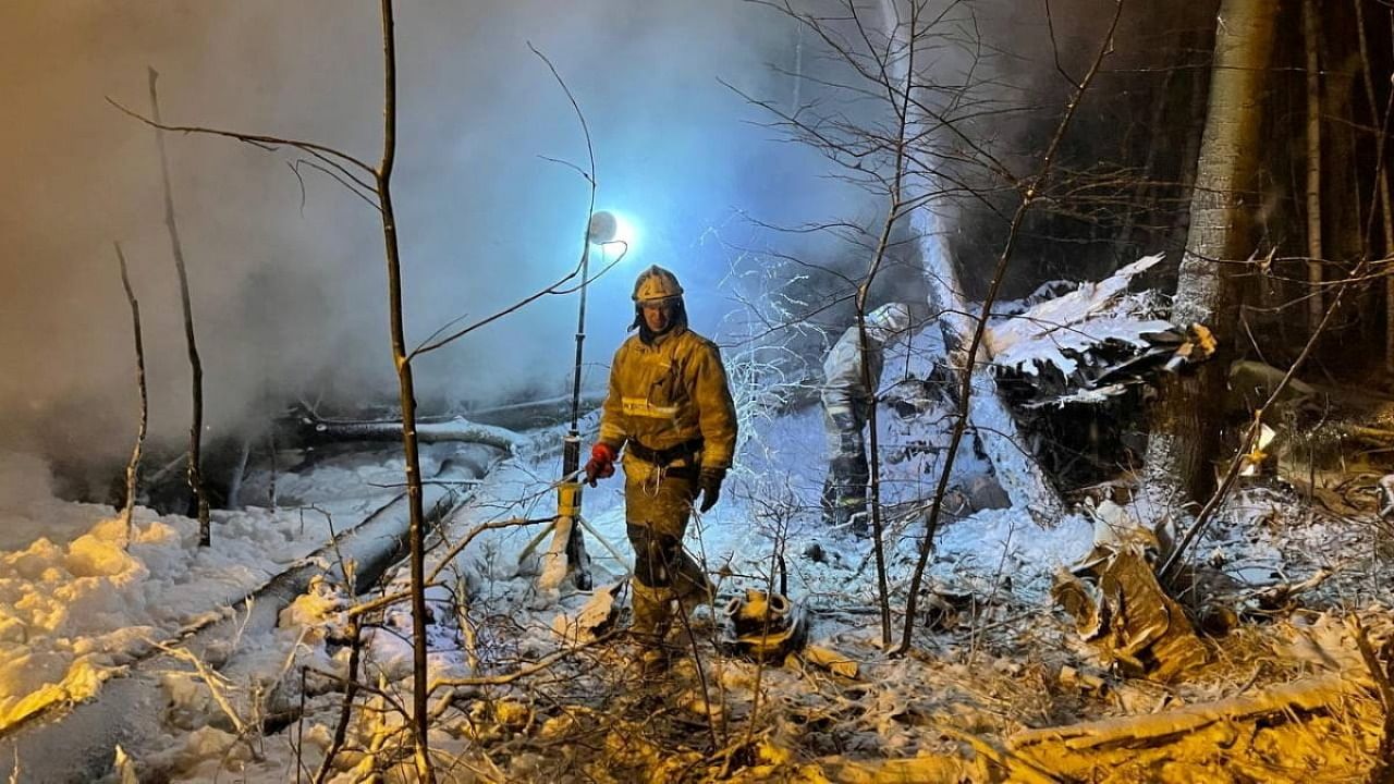 Emergency specialists work at the crash site of the Antonov An-12 cargo plane in Irkutsk Region. Credit: Reuters photo/Press service of the Governor of the Irkutsk region/Handout