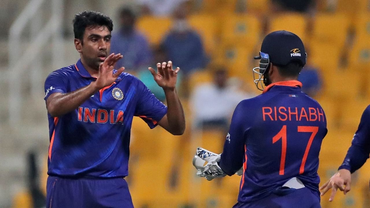 Ravichandran Ashwin (L) celebrates with teammates after dismissing Afghanistan's Gulbadin Naib during India's 66-run win in the T20 World Cup. Credit: AP/PTI Photo