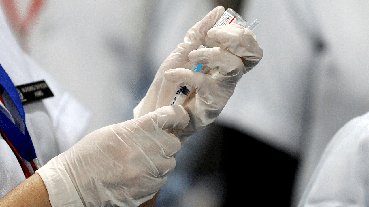 A healthcare worker fills a syringe with a dose of Bharat Biotech's Covid-19 vaccine called COVAXIN. Credit: Reuters Photo