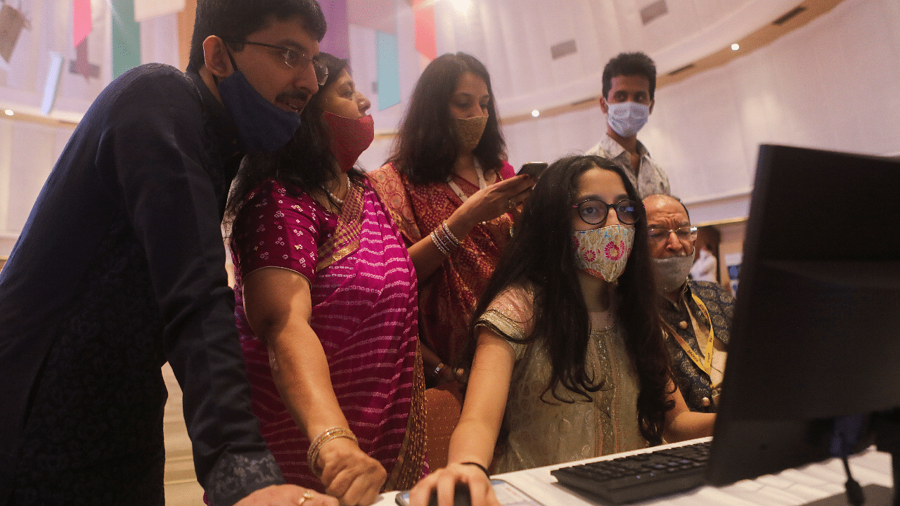 A stockbroker and his family watch a terminal during a special "muhurat" trading session for Diwali. Credit: Reuters File Photo