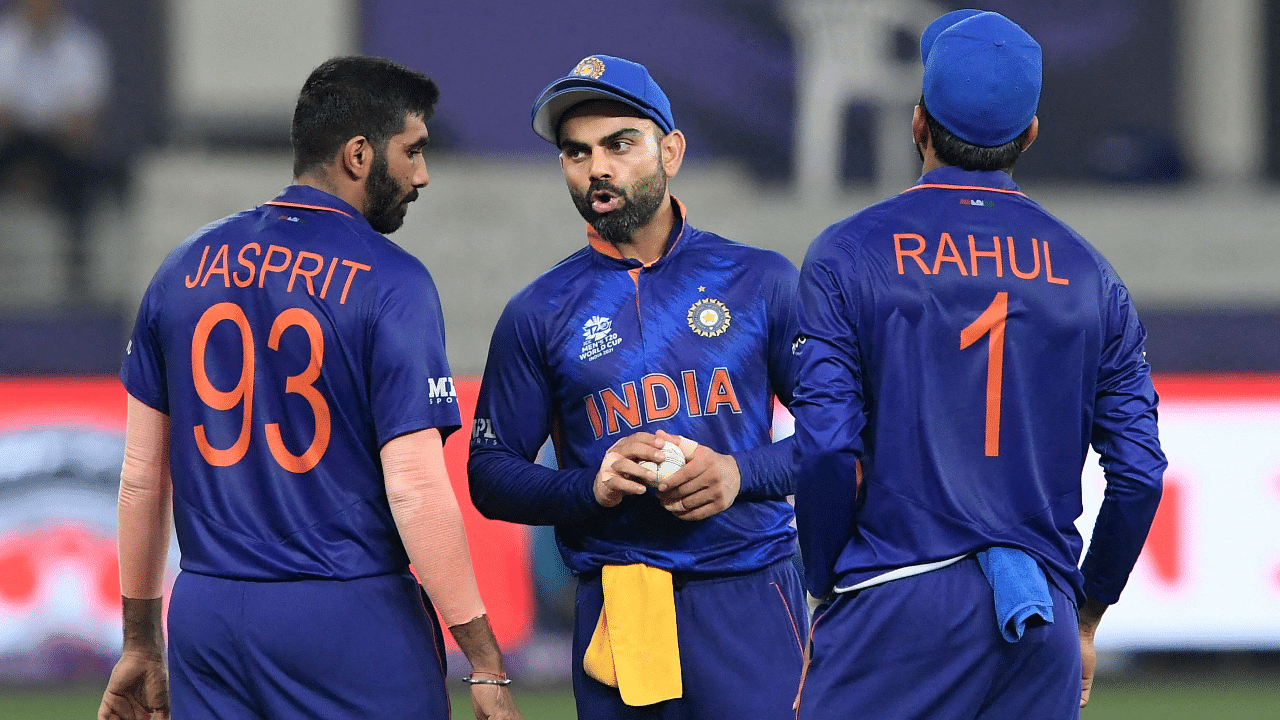 India's captain Virat Kohli (C) speaks with teammates Jasprit Bumrah (L) during the ICC men’s Twenty20 World Cup cricket match. Credit: AFP Photo