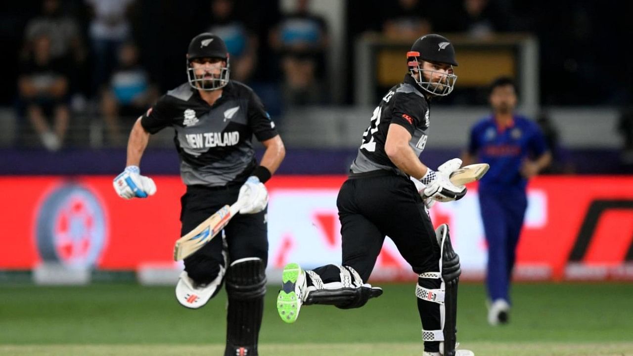 New Zealand's captain Kane Williamson (R) and teammate Daryl Mitchell run between the wickets during the ICC men’s Twenty20 World Cup cricket match. Credit: AFP File Photo