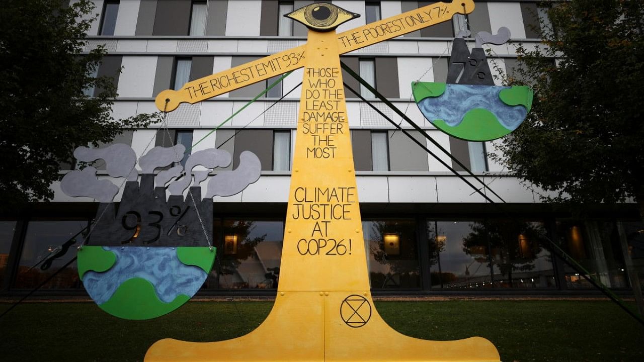 An installation called "Climate Justice Scales" is seen during the UN Climate Change Conference (COP26). Credit: Reuters File Photo