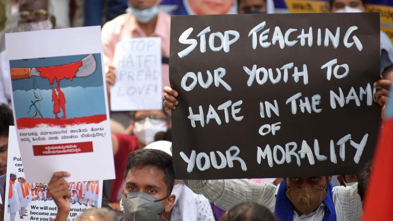 People from various organisations and citizen rights activists came together at SBM circle on Thursday condemning communal violence and demanding that the Chief Minister take back his 'action - reaction' statement on moral policing, in Bengaluru. Credit: DH photo