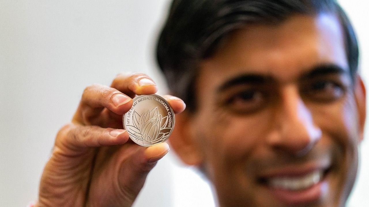 UK Chancellor Rishi Sunak unveils new commemorative Mahatma Gandhi coin in London. Credit: PTI Photo