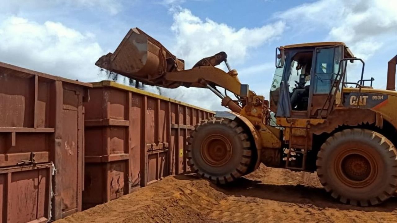 An excavator operator loads material into a train container. Credit: Special arrangement