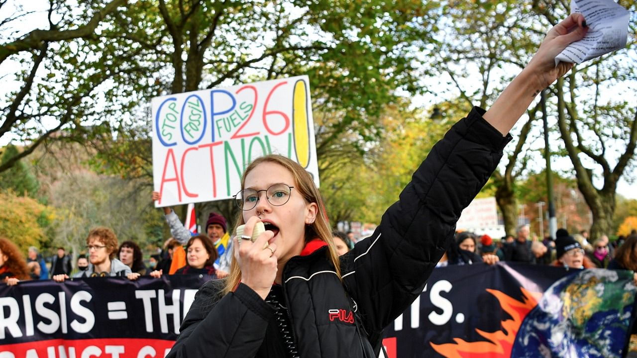 A demonstrator speaks through a megaphone as Youth activists protest in the Fridays for Future march. Credit: Reuters Photo