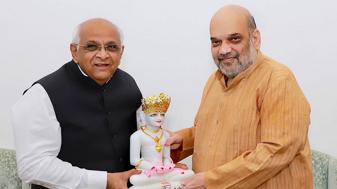 Gujarat Chief Minister Bhupendra Patel with Amit Shah. Credit: PTI File Photo