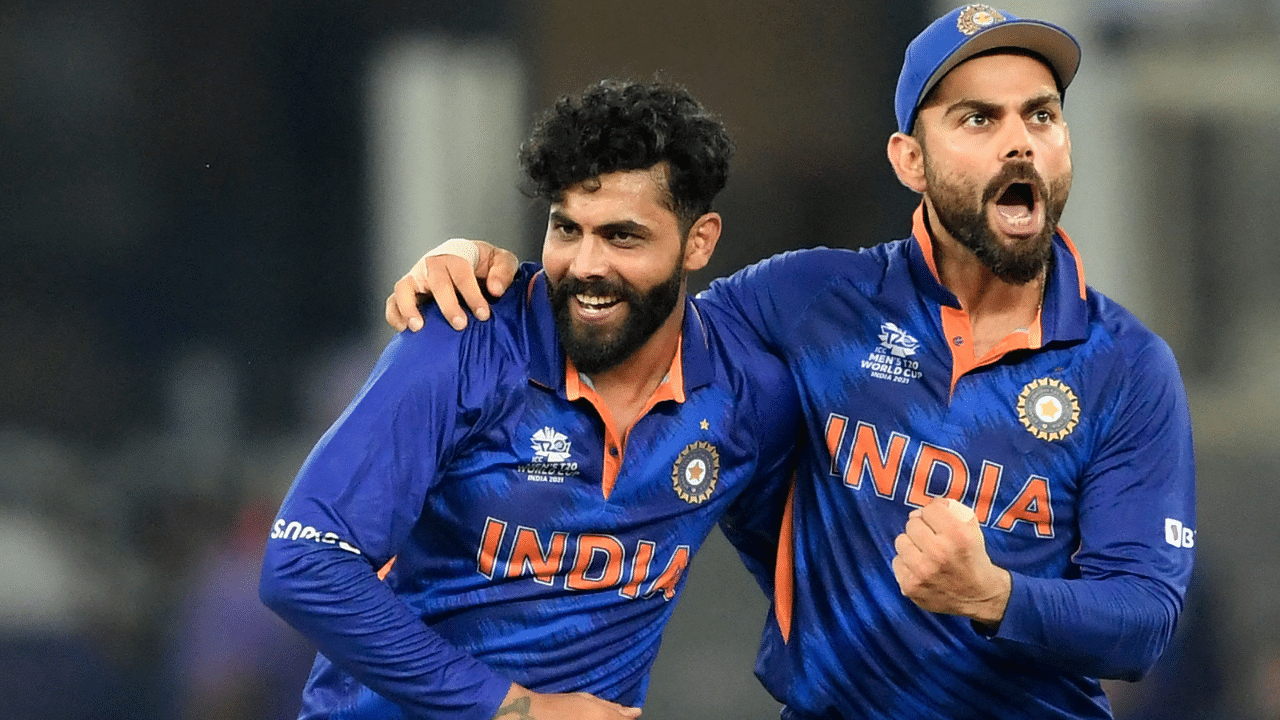 India's Ravindra Jadeja (L) celebrates with captain Virat Kohli after taking the wicket of Scotland's Matthew Cross. Credit: AFP Photo