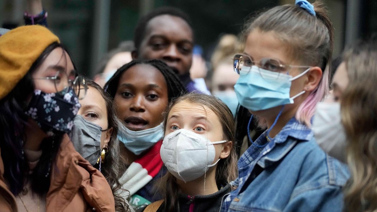 Greta Thunberg, center, demonstrates in front of the Standard Chartered Bank during a climate protest in London. Credit: AP Photo