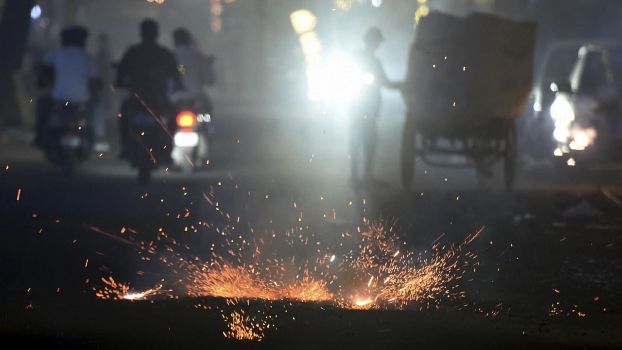 People burn firecrackers to celebrate Diwali festival, in New Delhi. Credit: PTI Photo