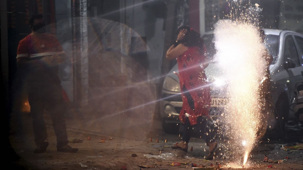 People burn firecrackers to celebrate Diwali festival, in New Delhi. Credit: PTI File Photo