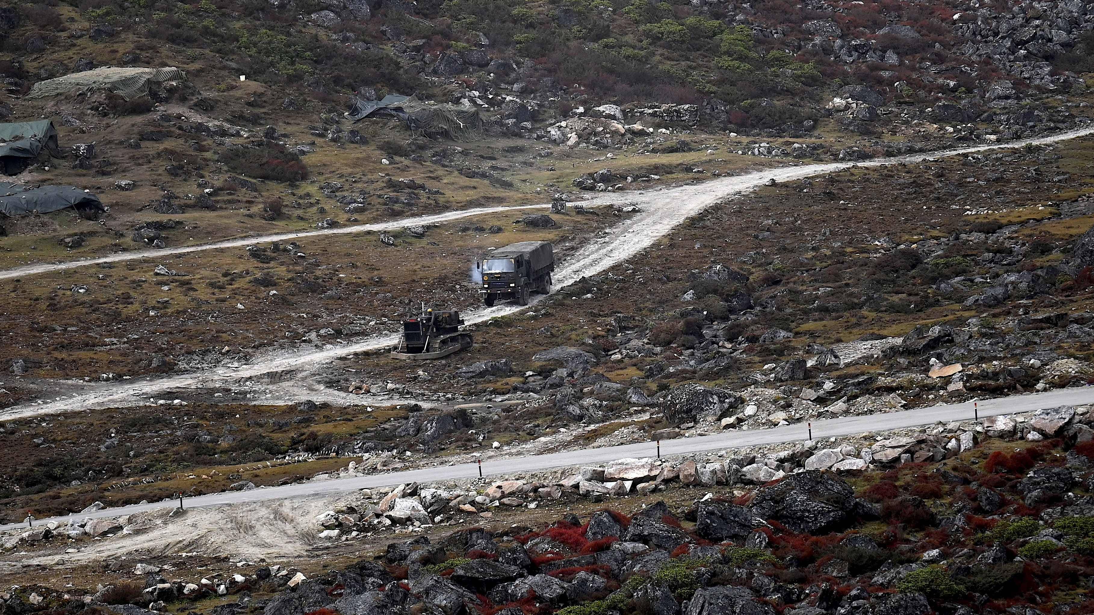 An Indian Army truck drives along a road to Tawang, near the Line of Actual Control (LAC), neighbouring China, near Sela Pass in India's Arunachal Pradesh. Credit: AFP Photo