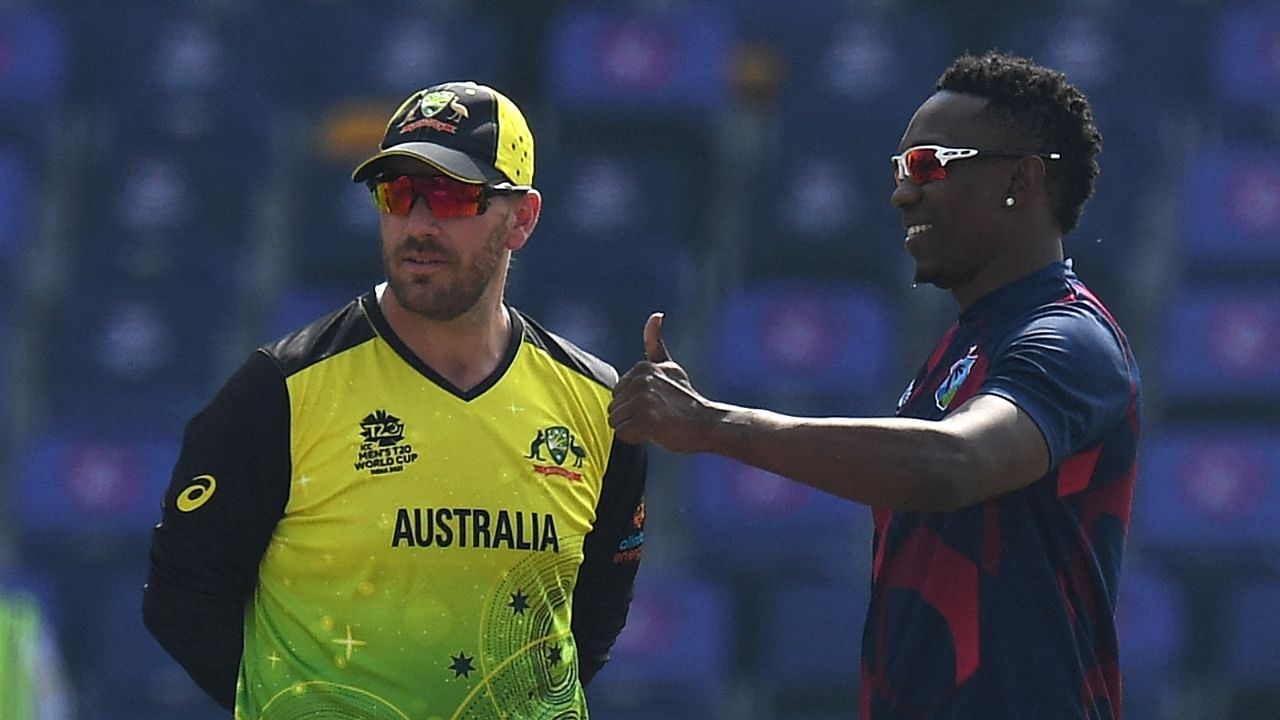 West Indies' Dwayne Bravo (R) gestures as Australia's captain Aaron Finch watches before the start of the ICC men’s Twenty20 World Cup cricket match between Australia and West Indies. Credit: AFP File Photo