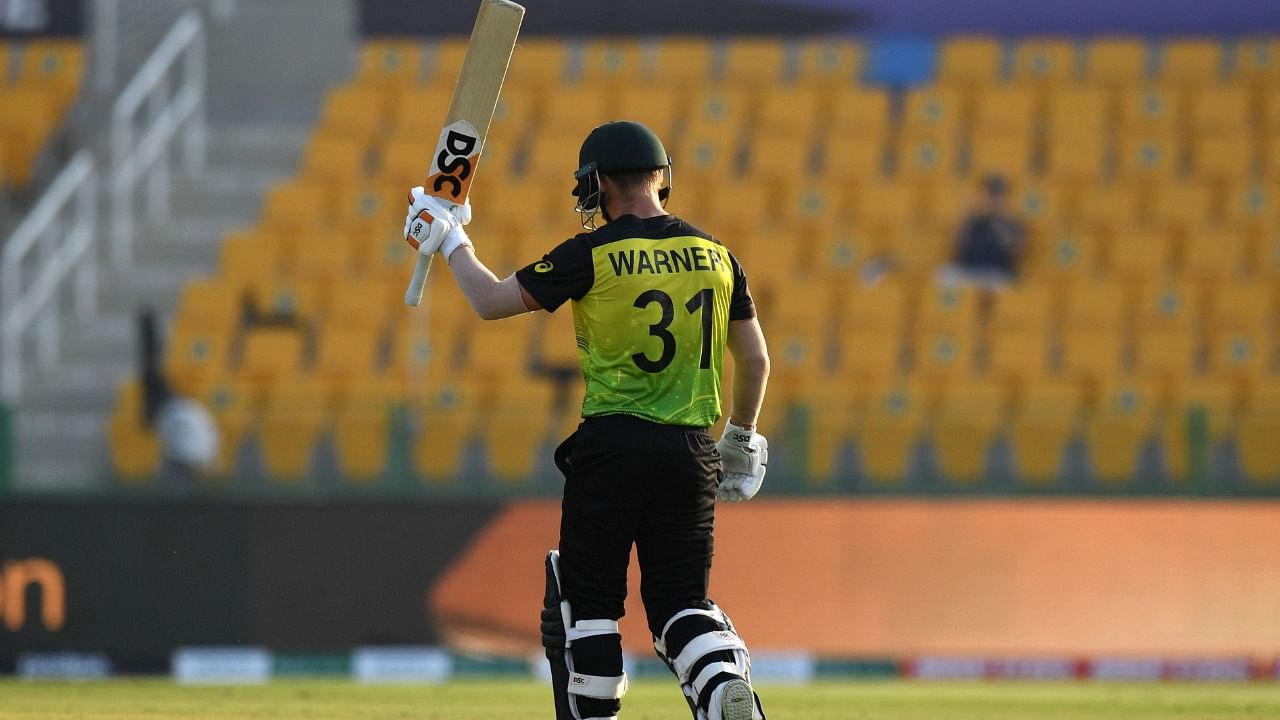 Australia's David Warner celebrates after scoring a half-century during the ICC men’s Twenty20 World Cup cricket match between Australia and West Indies. Credit: AFP Photo
