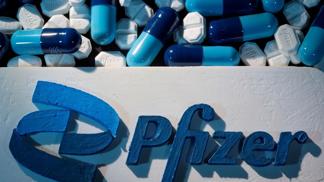 A 3D printed Pfizer logo is placed near medicines from the same manufacturer in this illustration. Credit: Reuters File Photo