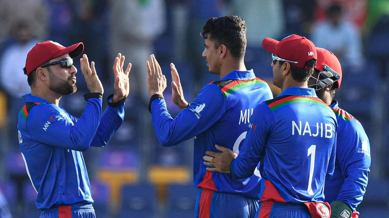 Afghanistan's cricketers celebrate after the dismissal of New Zealand's Daryl Mitchell. Credit: AFP Photo