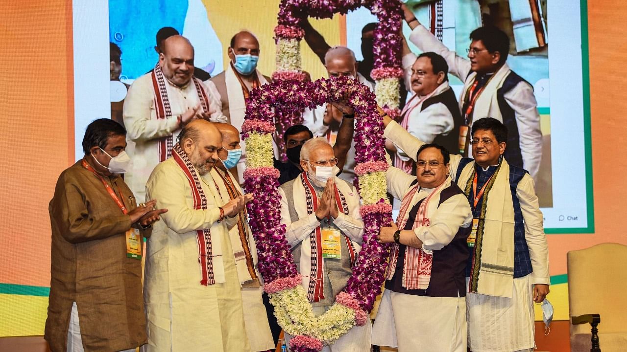 Modi being felicitated with a garland by BJP leaders. Credit: PTI Photo