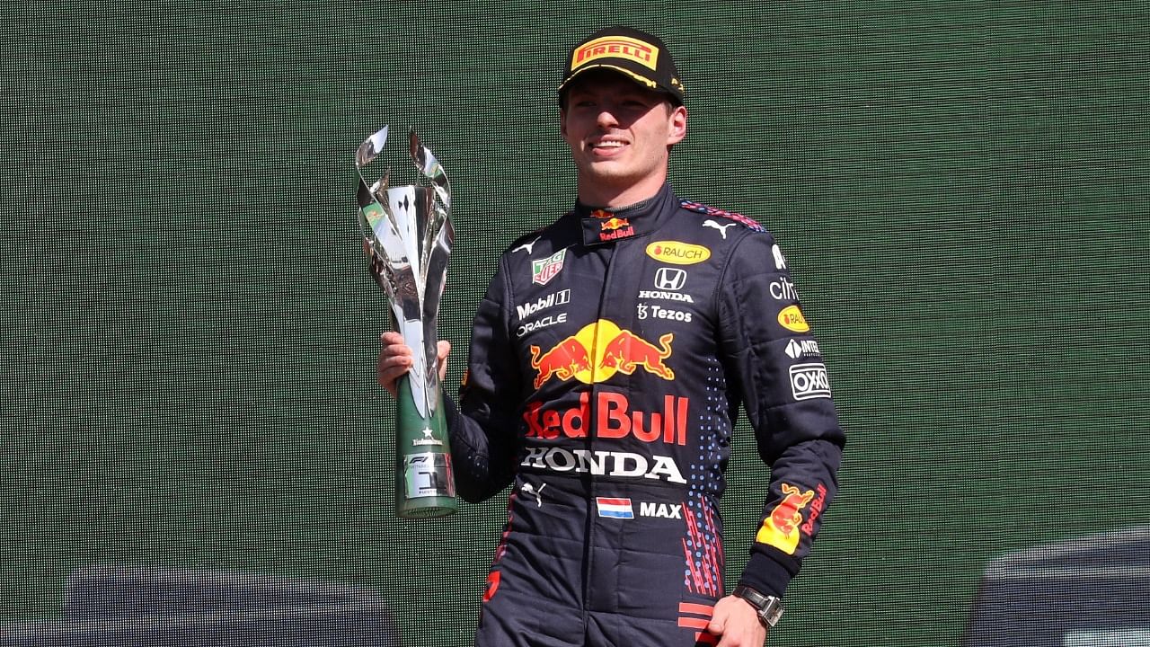 Red Bull's Max Verstappen celebrates on the podium after winning the Mexico Grand Prix. Credit: Reuters Photo